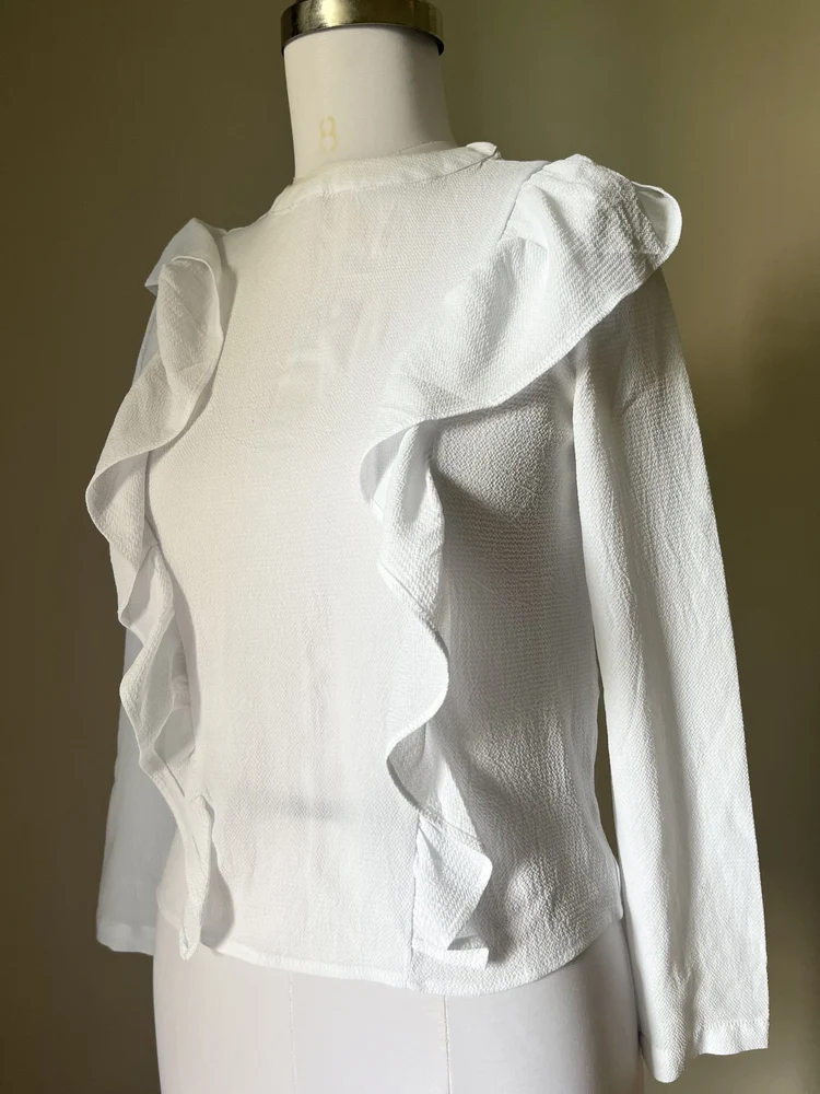 White ruffle shirt-style top