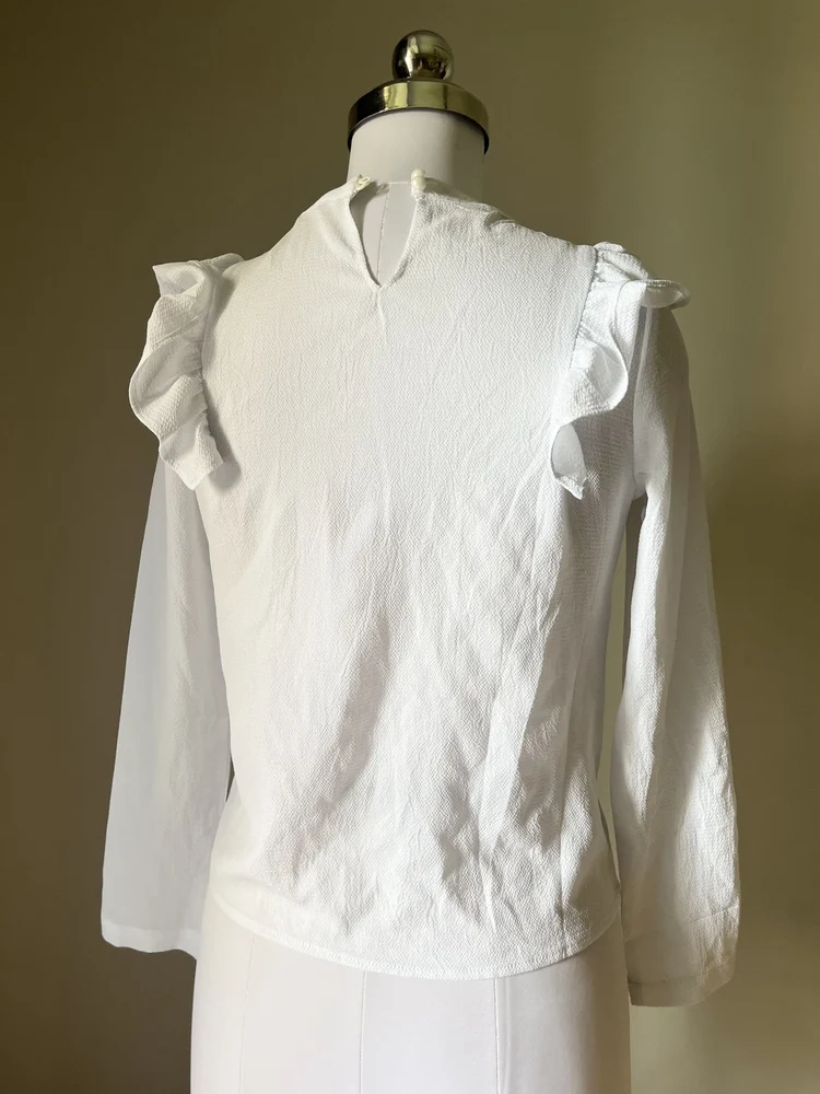 White ruffle shirt-style top