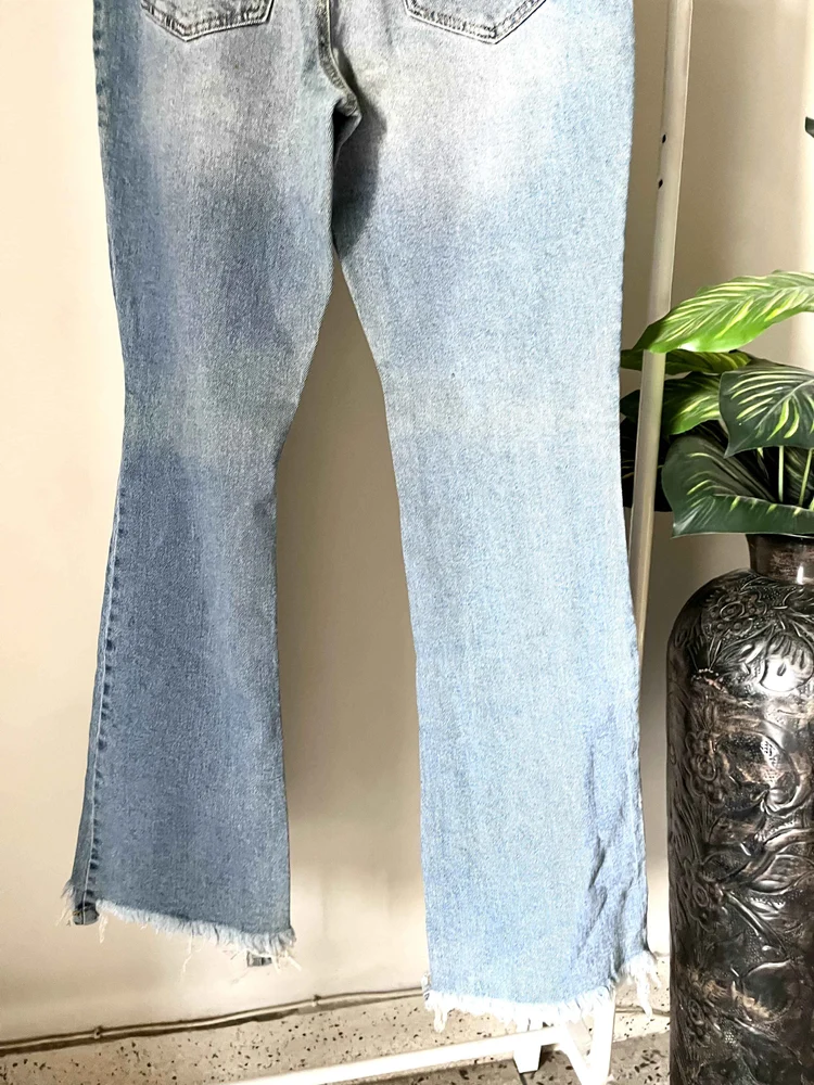 Blue bell-bottom ripped denim 
